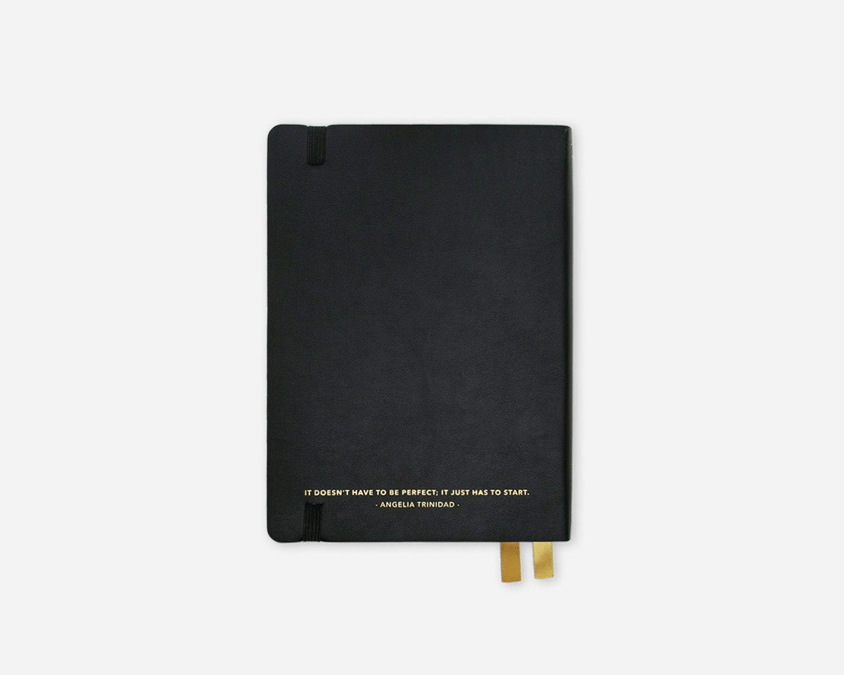 Black notebook with gold accents on a white background
