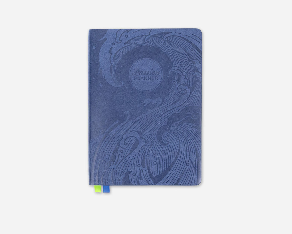 Blue planner with a decorative wave on the cover on a white background