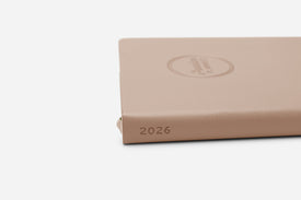 Beige planner with '2026' embossed on a white background