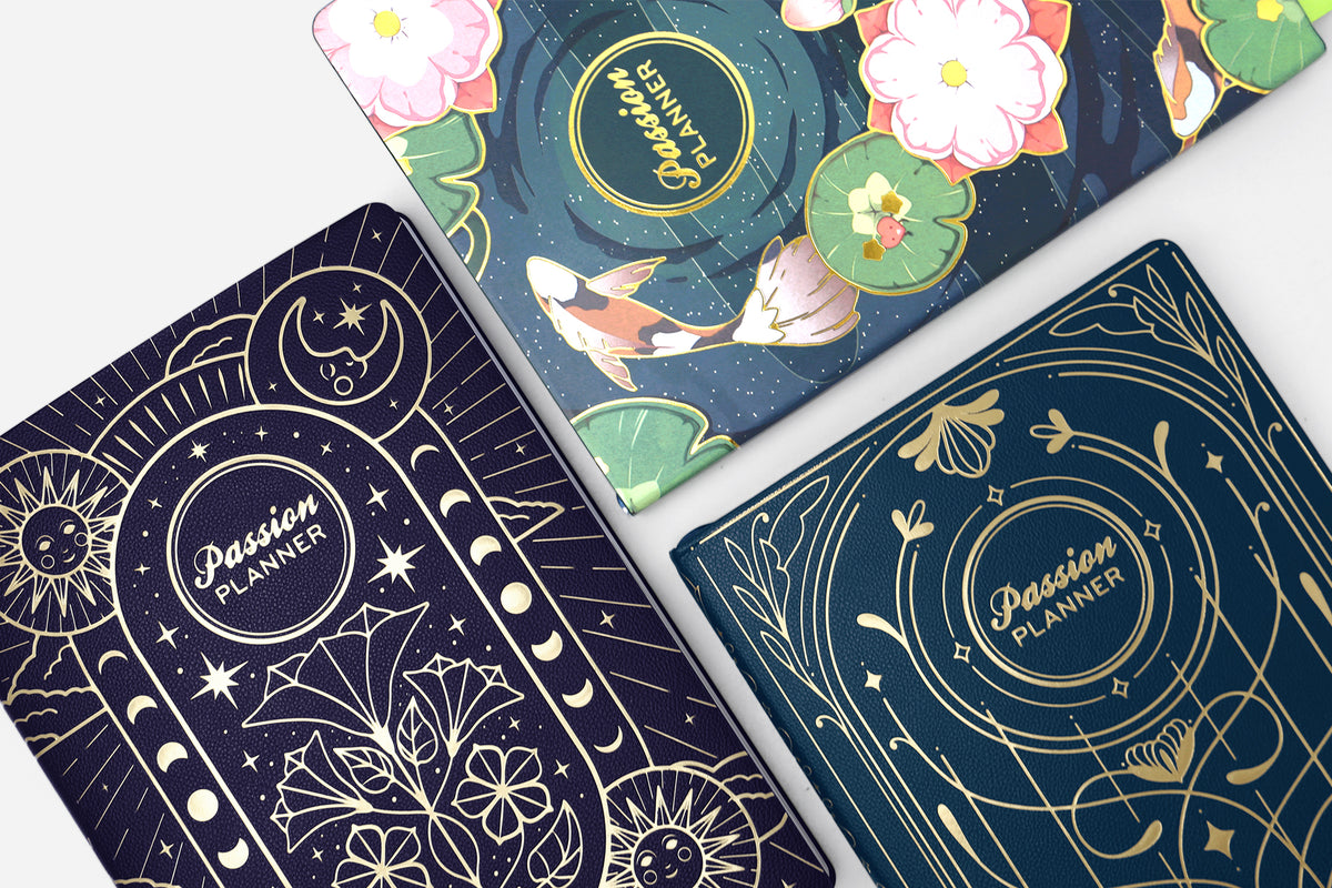 Three planner covers with celestial designs and 'Passion Planner' branding.