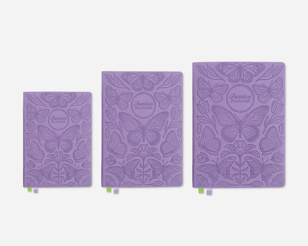 Three purple planners in different sizes with butterfly design on a white background