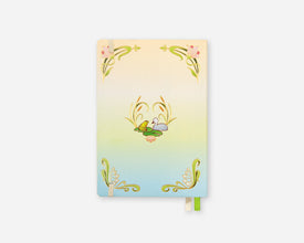 A vertical planer with a pastel gradient cover transitioning from pale yellow at the top to light blue at the bottom, decorated with green botanical scrollwork and small pink floral accents. A green ribbon bookmark and a white page tab are visible at the bottom edge, set against a plain light gray background.