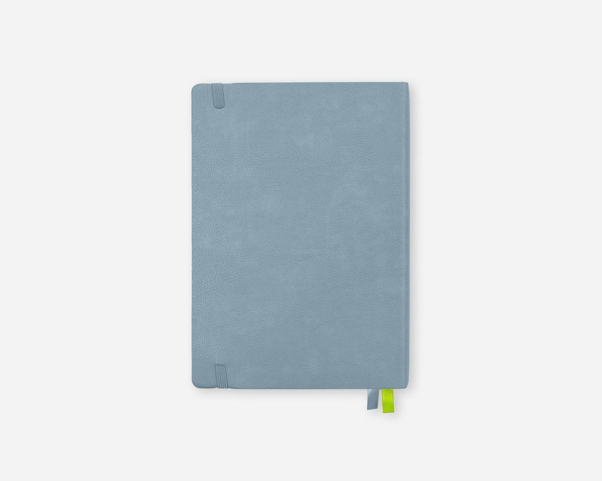 A light blue 2027 planner with a textured cover, featuring a small green ribbon bookmark peeking out from the bottom right corner, set against a plain light gray background.