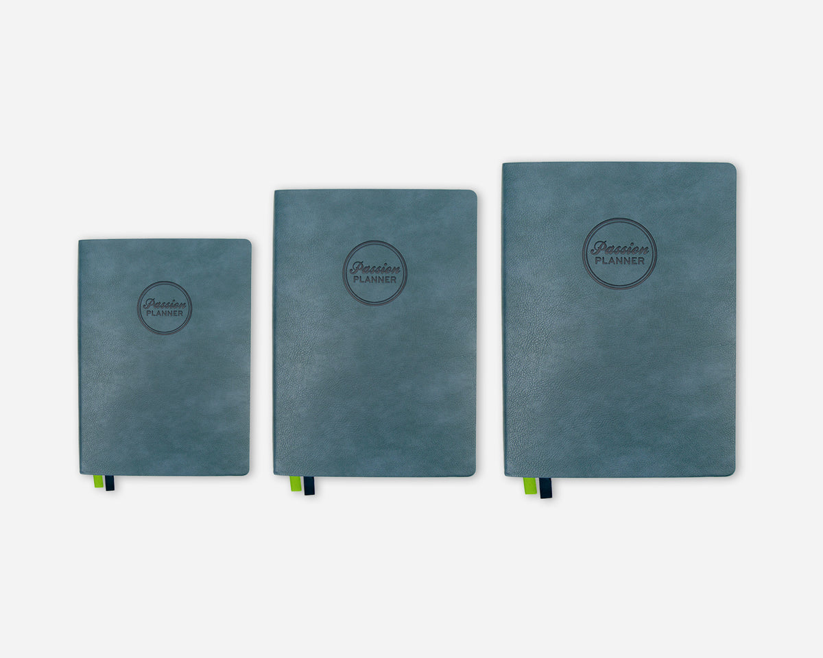 Three teal 2027 planners in different sizes lined up horizontally on a light gray background. Each notebook features a circular embossed logo that reads 'Passion Planner' and has a small green ribbon bookmark peeking out from the bottom.