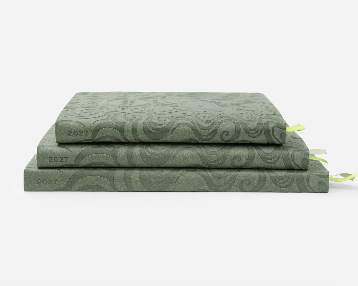 Three stacked sage green faux leather planners, each labeled '2027' on the spine, with small ribbon bookmarks peeking out on a clean white background.