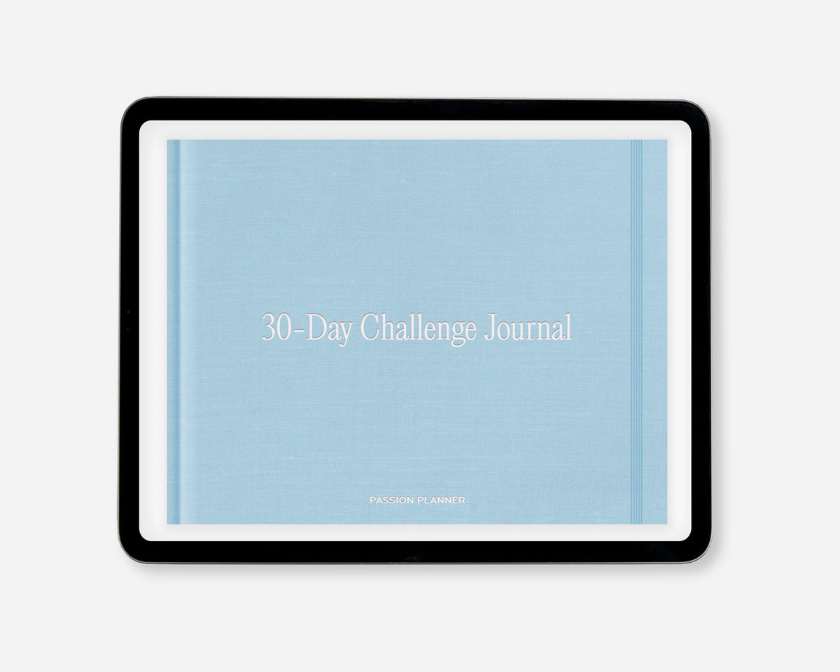 A 30-Day Challenge Journal by Passion Planner, featuring a light blue textured cover with white text, within a black tablet screen, shown on a light gray background.