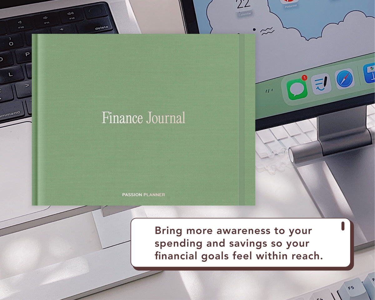 A sage green digital 'Finance Journal' by Passion Planner is displayed on a desk in front of a laptop and computer monitor, with a promotional text bubble at the bottom.