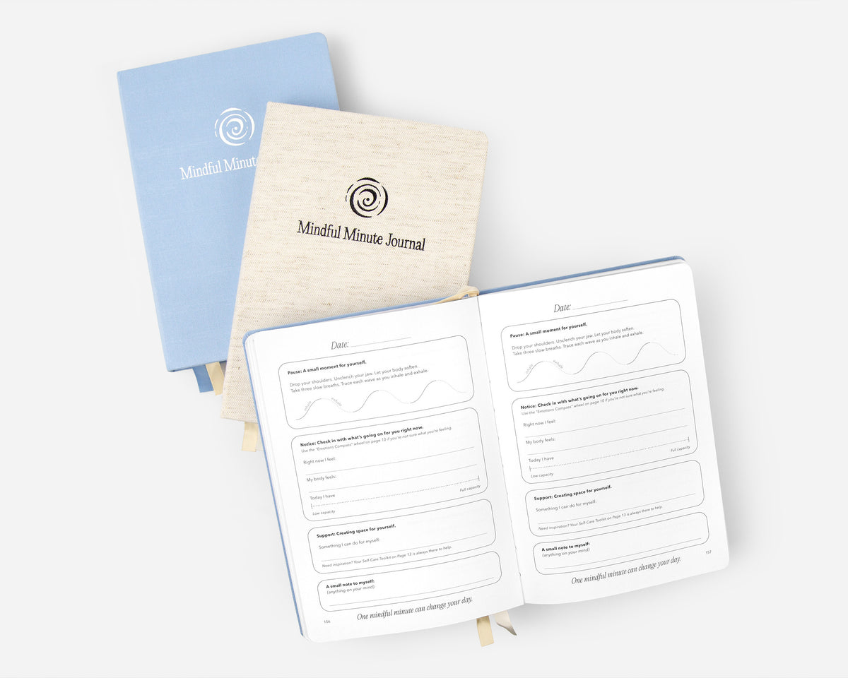Two closed Mindful Minute Journals with one open journal on a light gray background.